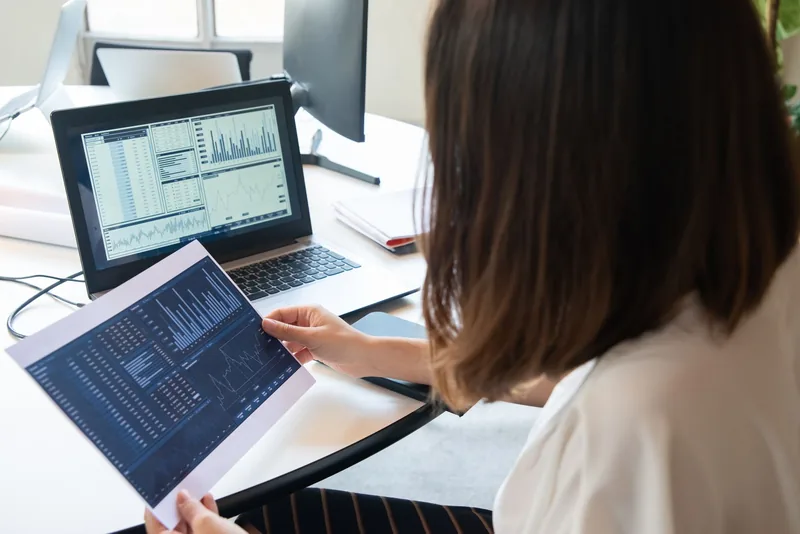Person reviewing an analytics dashboard on a laptop in an office