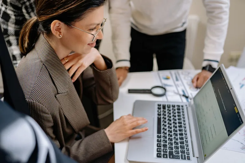 Marketer reviewing a prospect list and campaign data on a laptop