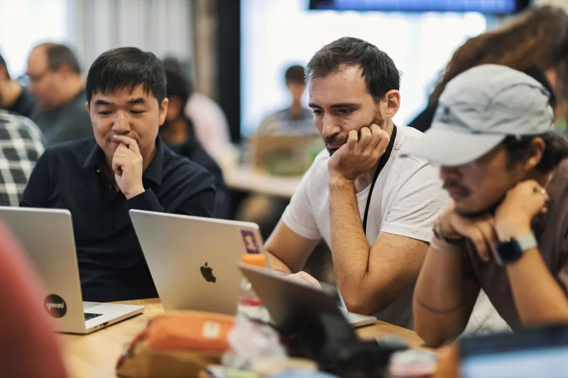 Team comparing email marketing software options on laptops