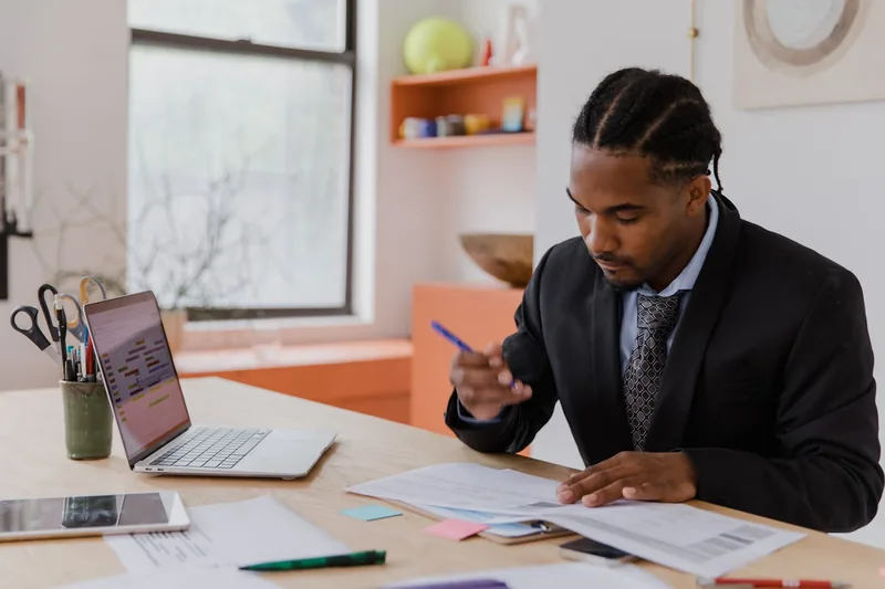 Small business owner reviewing software subscription costs at a desk