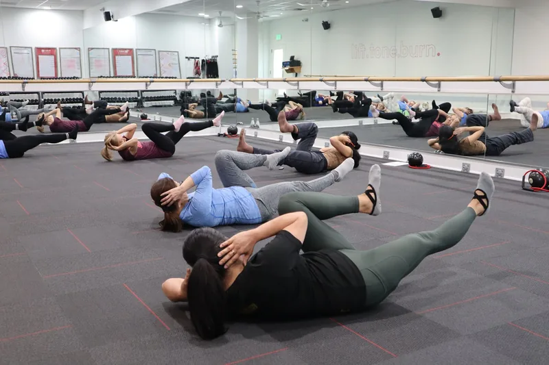A full group fitness class working out together in a gym