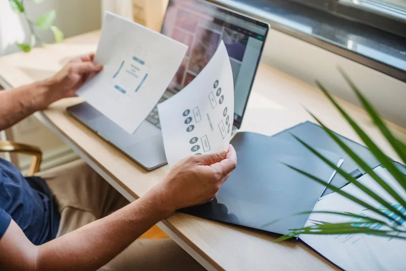 Web designer building a custom website layout on a computer