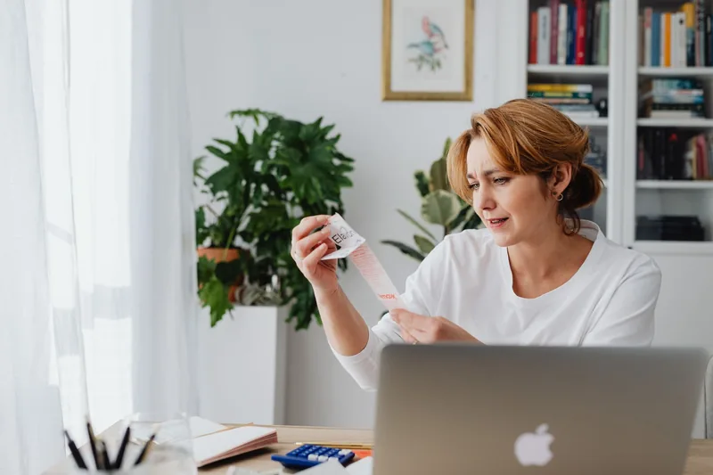 Small-business owner reviewing an SEO budget on a laptop