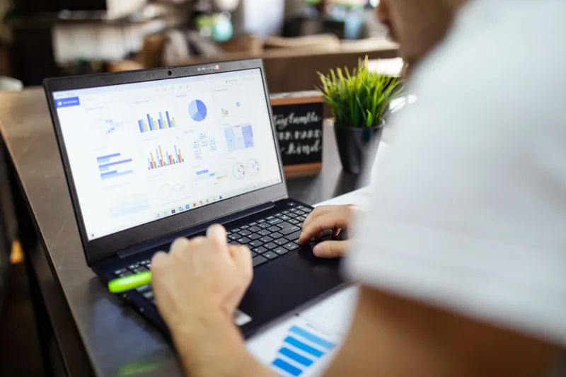 Marketer reviewing campaign performance charts on a laptop