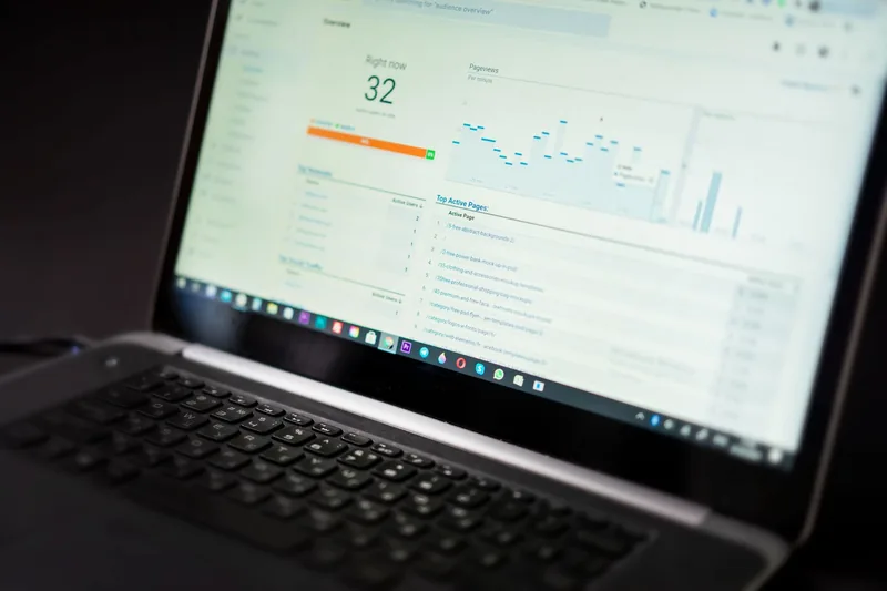 Laptop screen showing an analytics dashboard with traffic and conversion data