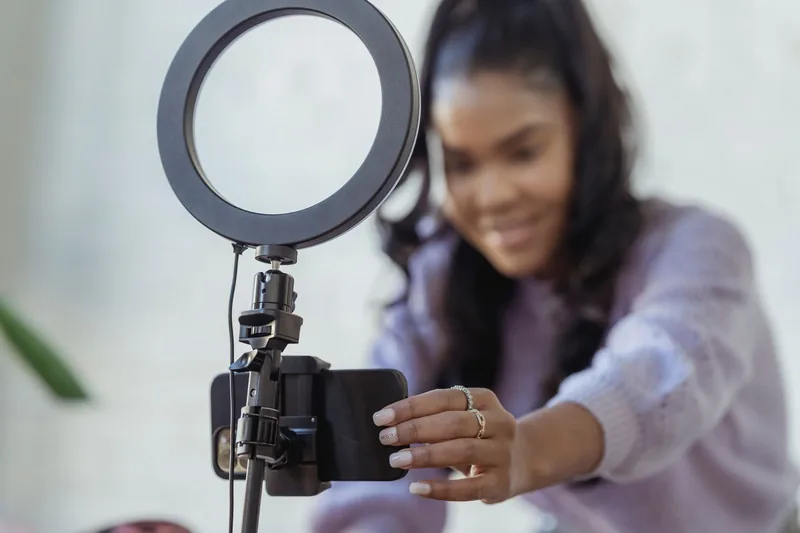 Small-business owner setting up a phone on a tripod to film social content