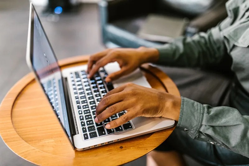 Small business owner reviewing an automated workflow on a laptop