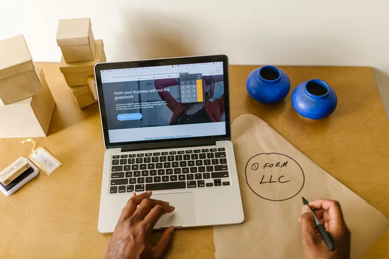 A small-business owner weighing a website platform decision at their desk